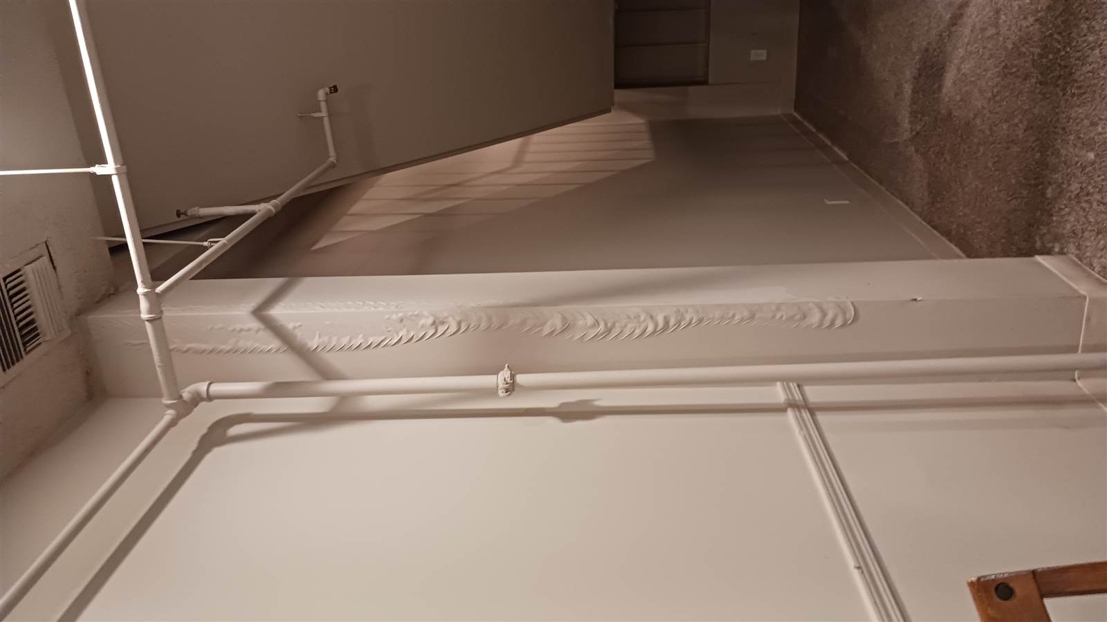 Wet lobby floor with an orange bucket