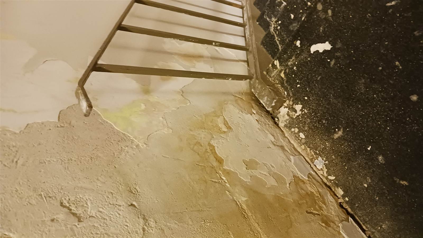 Flooded first-floor stairwell with caution tape